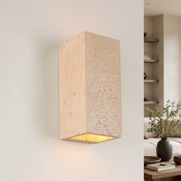 Cubo cement wall light with travertine finish showing up and down light beams on white wall