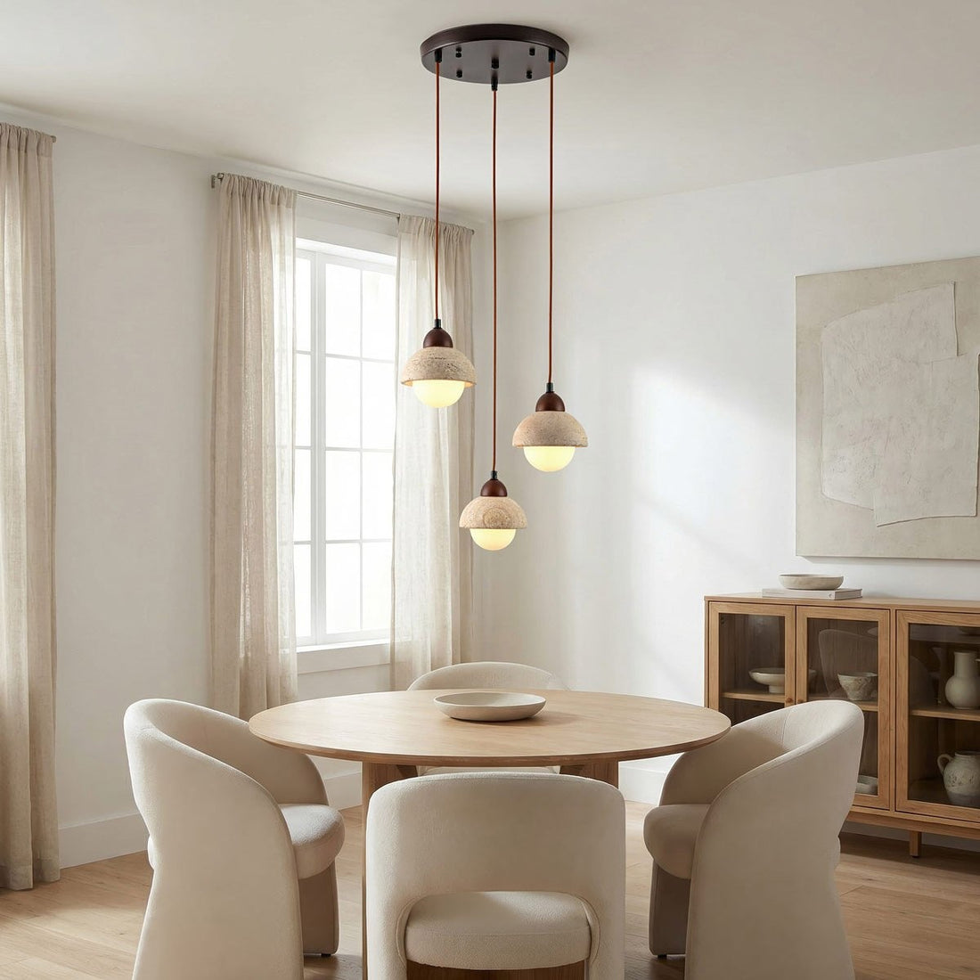 Close up of travertine and glass pendant light showing natural stone texture and soft diffused glow