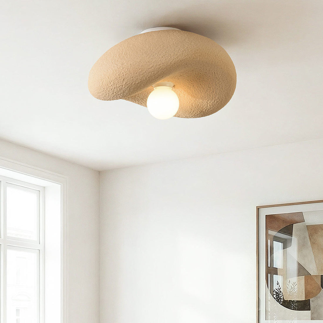 Close-up of Kaia ceiling light showing natural stone texture and asymmetrical design