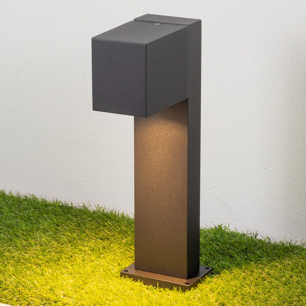 Wi-Fi enabled outdoor post light casting coloured glow on garden border and pathway