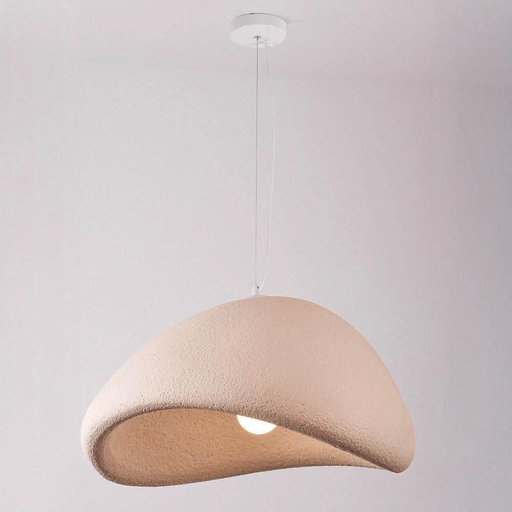 Dusty pink sculptural pendant light illuminated showing warm ambient glow