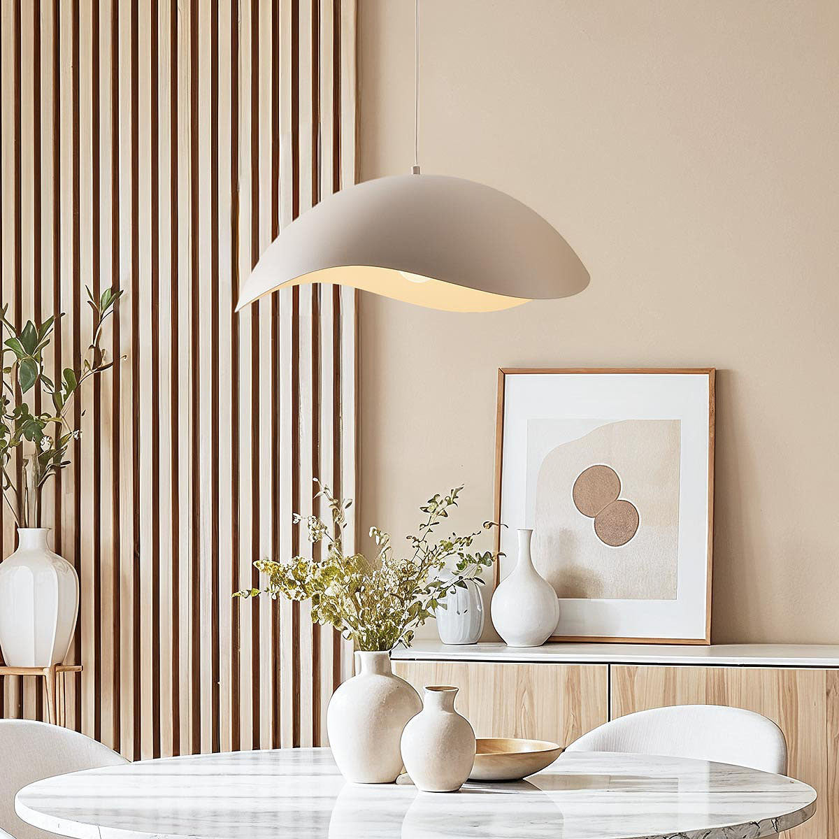 Nami wavy metal pendant light in sand taupe hanging from ceiling