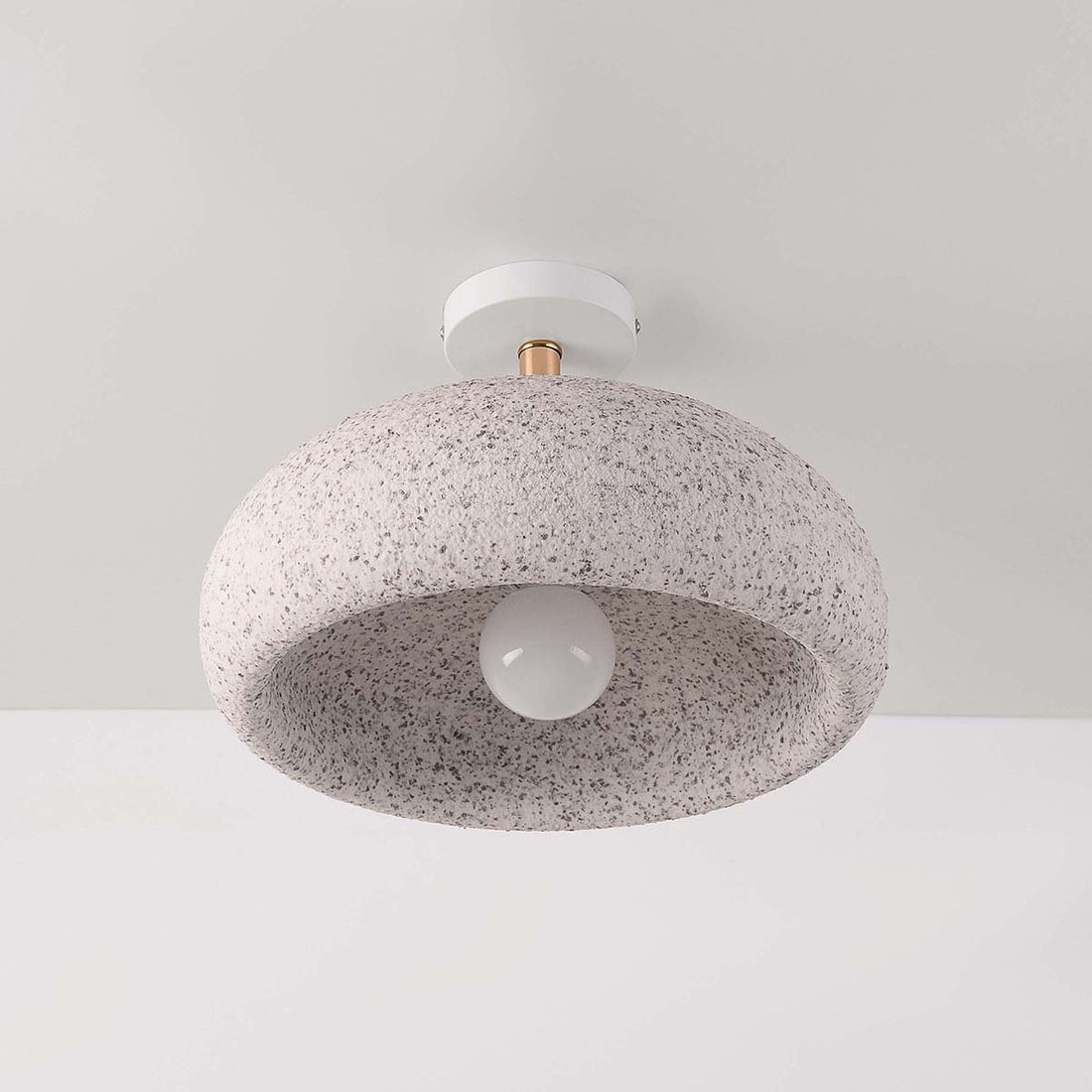 Zola terrazzo-effect ceiling light illuminated showing gentle downward light spread