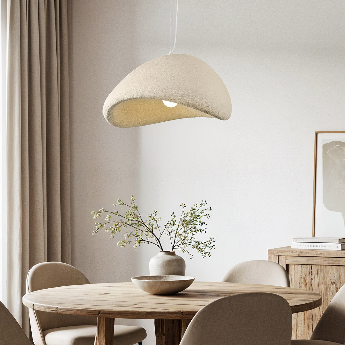 Kara sand beige stone-effect pendant light hanging above dining table