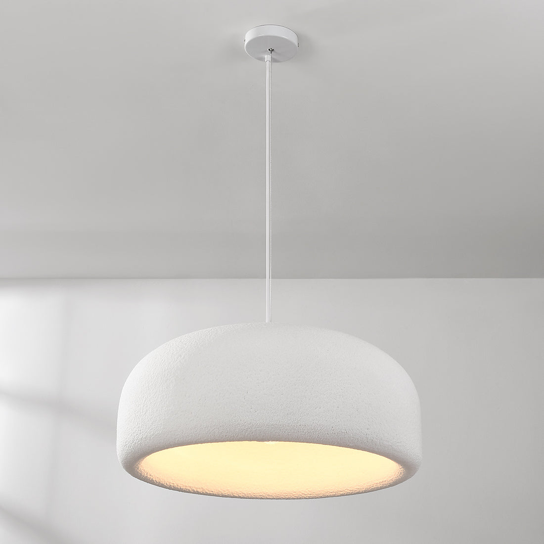 Close-up of Shiro pendant light showing white stone texture and soft glow