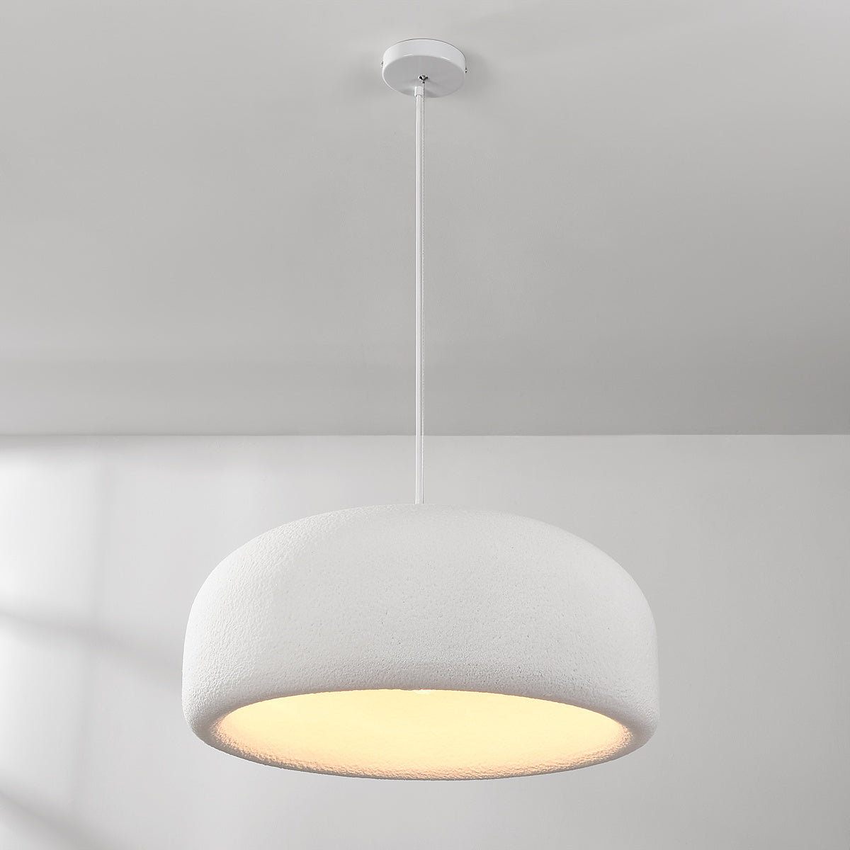 Close-up of Shiro pendant light showing white stone texture and soft glow