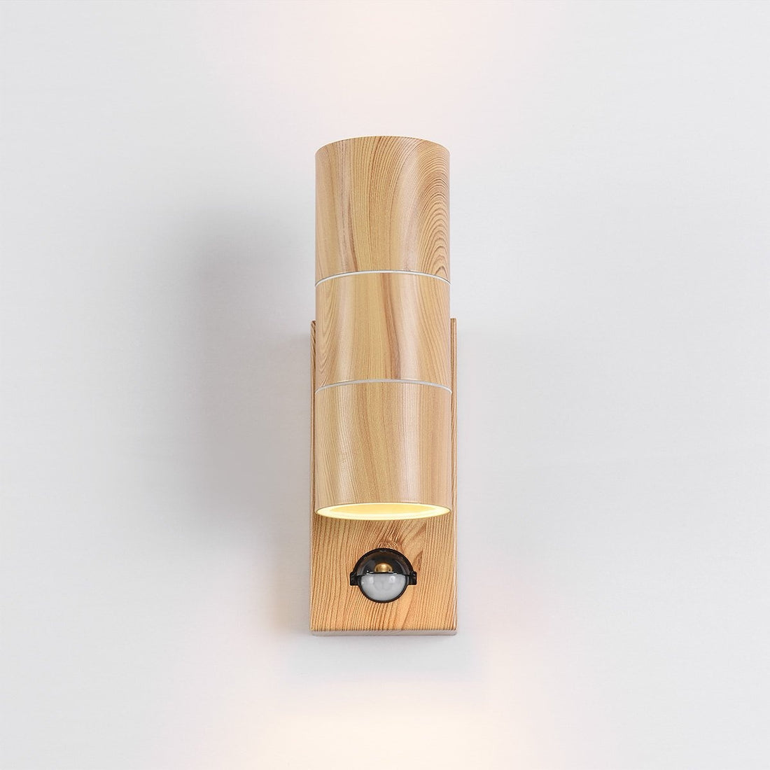 Elm outdoor sensor light illuminating garden pathway at night with warm LED glow