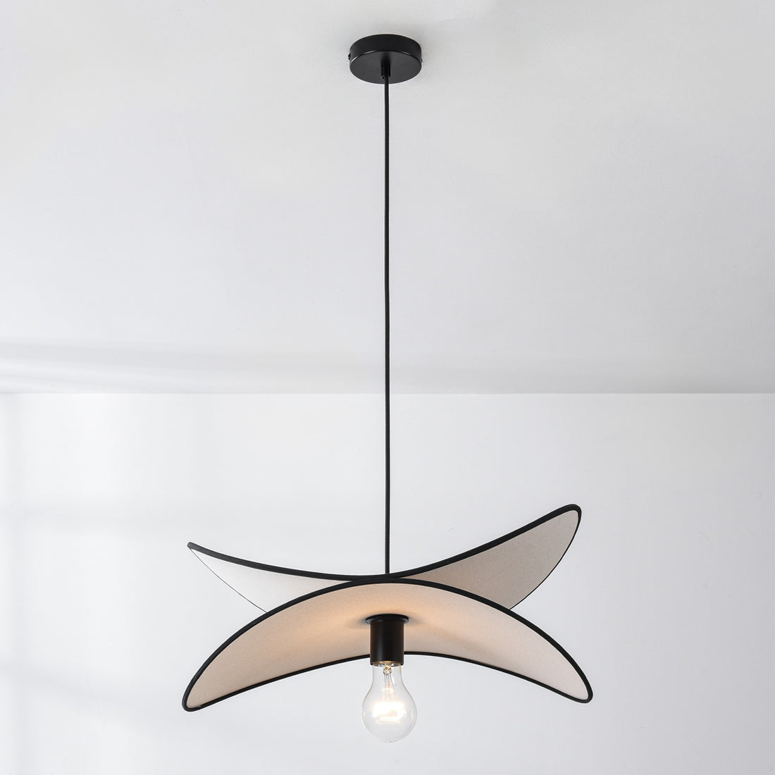 Suki linen pendant light illuminated creating warm ambient glow in contemporary living space