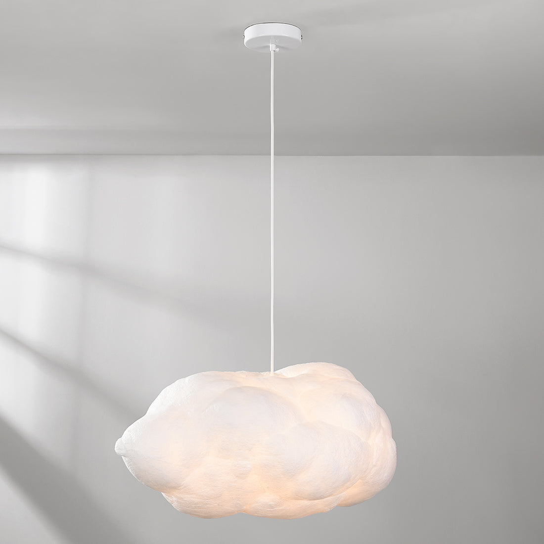 Medium white Nuvola cloud light fixture creating soft ambient glow in bedroom