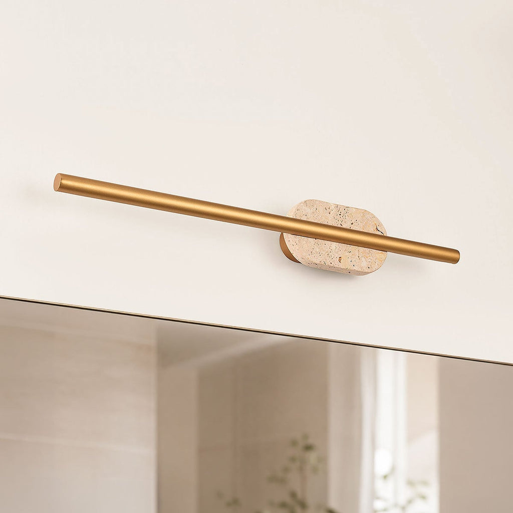 Close-up of Isola wall light showing travertine stone detail and gold finish
