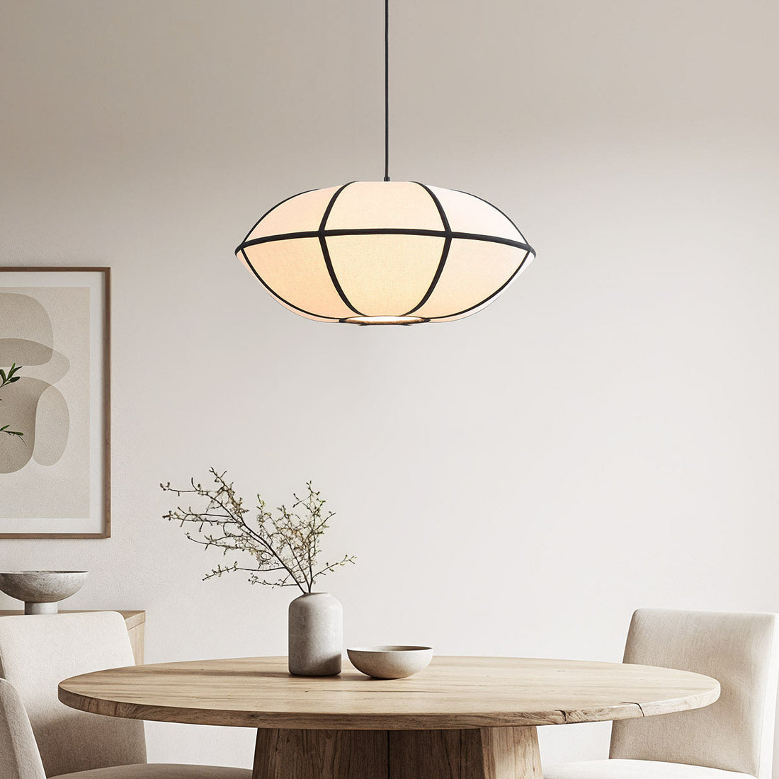 Ren beige linen pendant light with black trim hanging in modern interior
