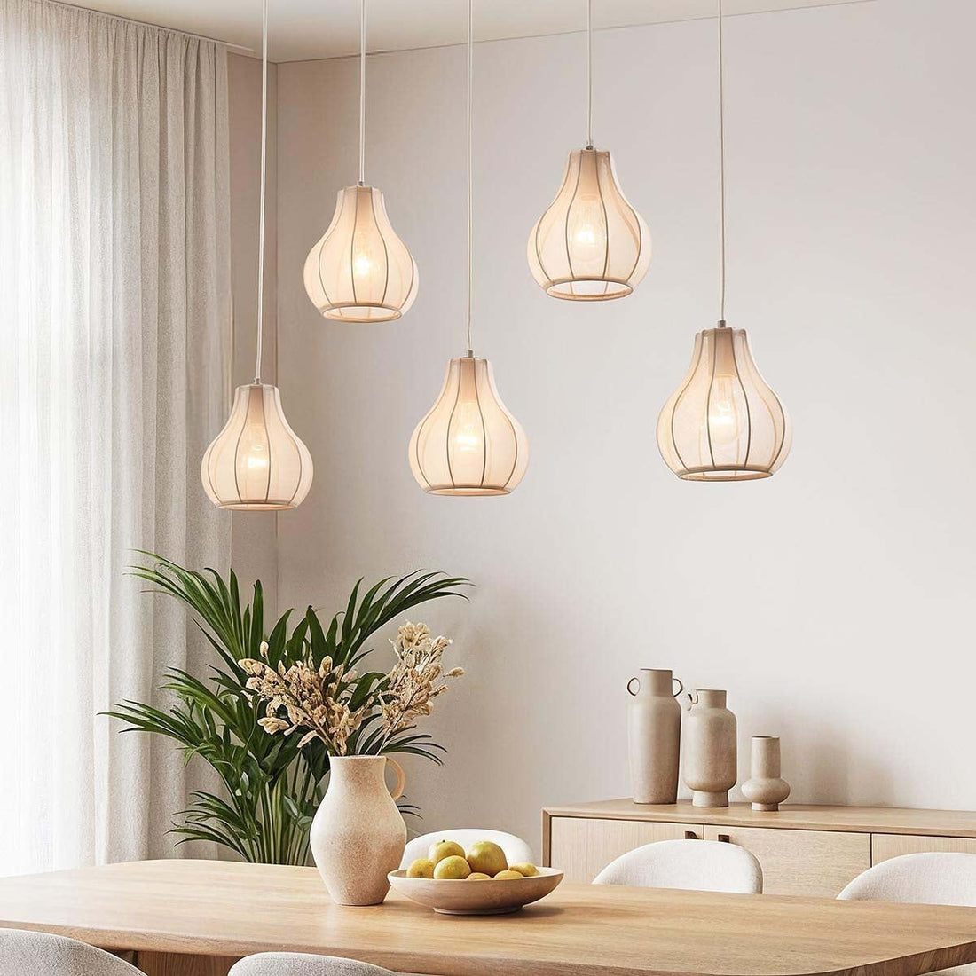 Aiko five-light linen pendant bar in sand taupe hanging above dining table