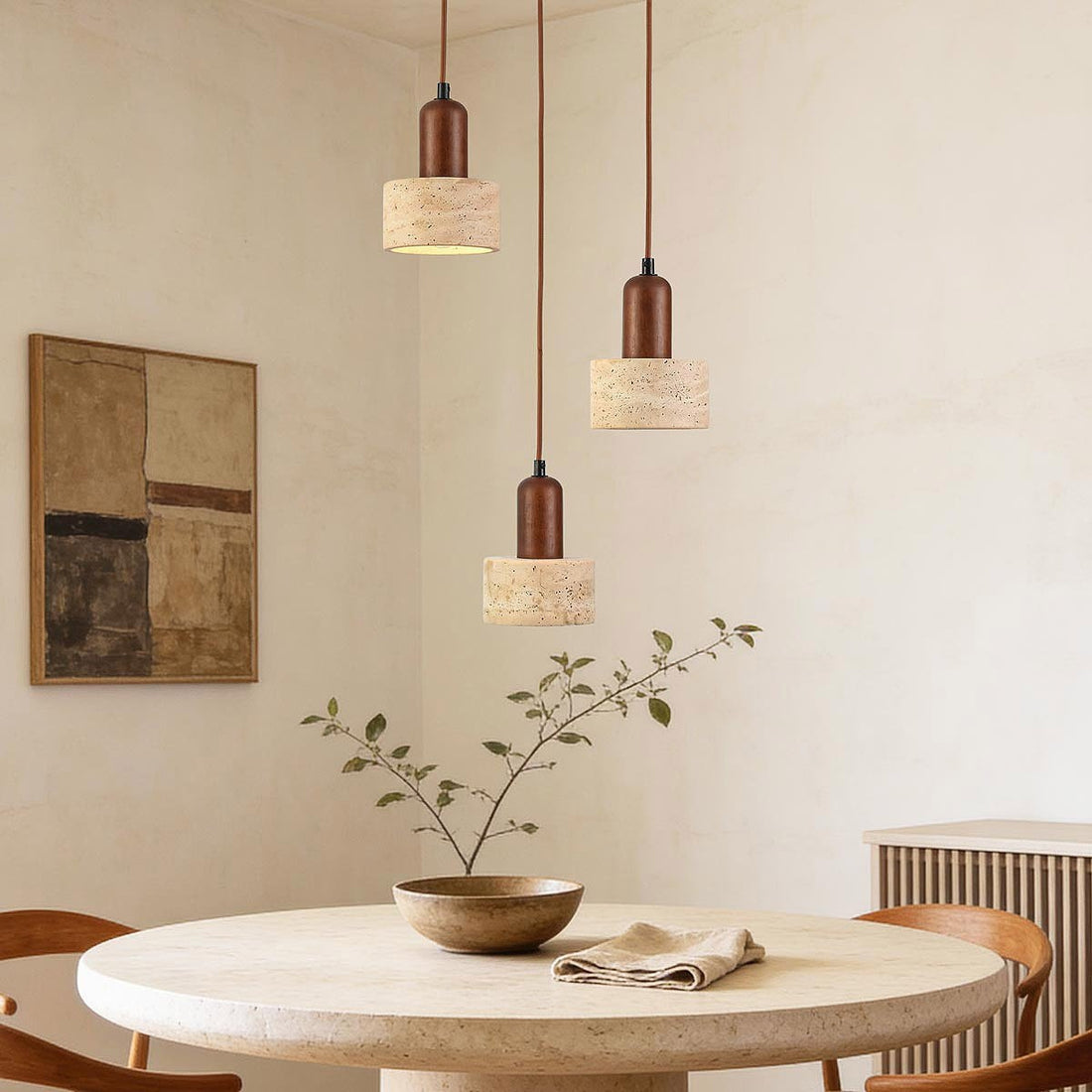 Taoka travertine and wood three light pendant suspended over dining table