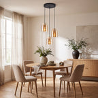 Close up of travertine and brass fixture on Akiko amber glass pendant light