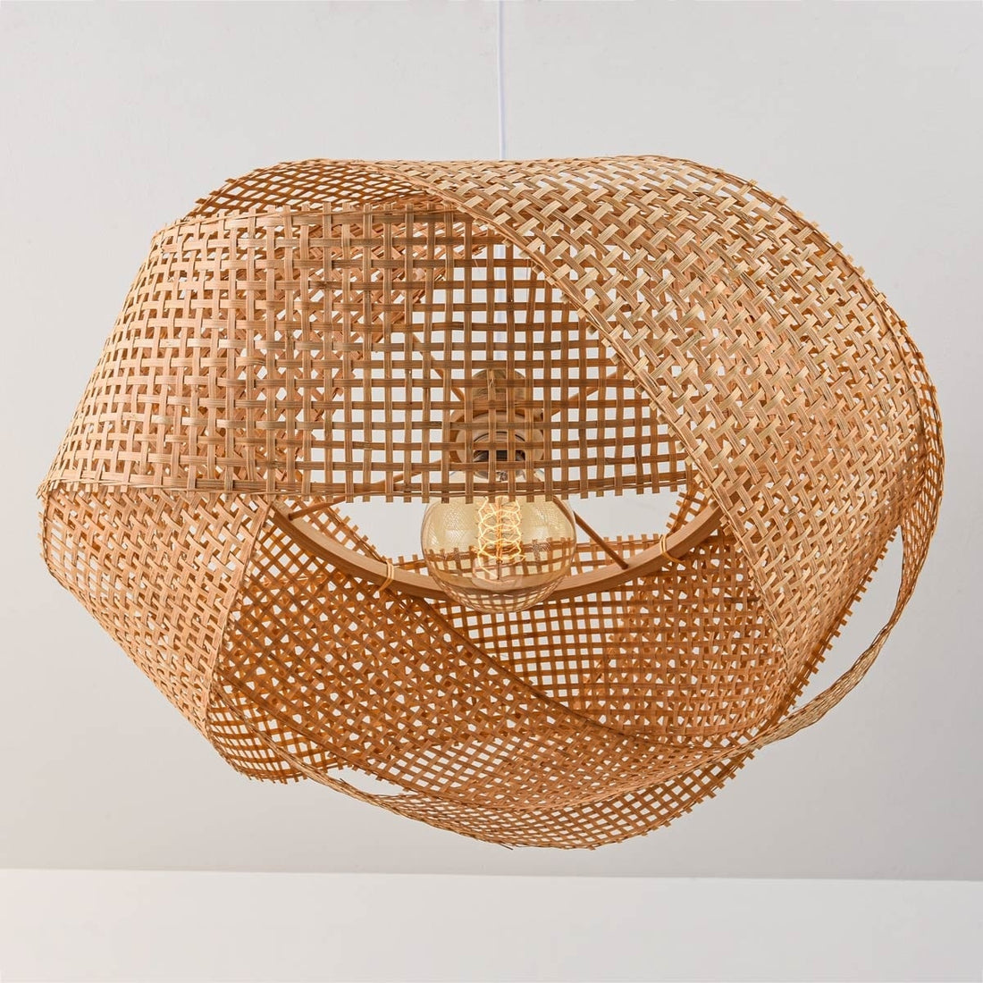 Kumi bamboo pendant light illuminated in modern dining room interior