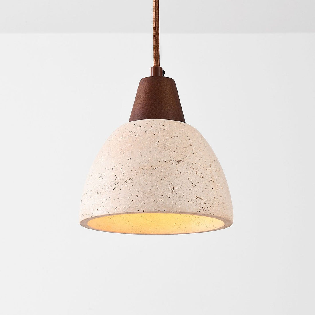 Sand beige travertine pendant lamp hanging in modern interior setting