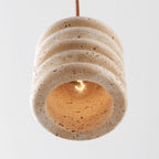 Kyoto cylindrical pendant light in beige showing travertine texture detail