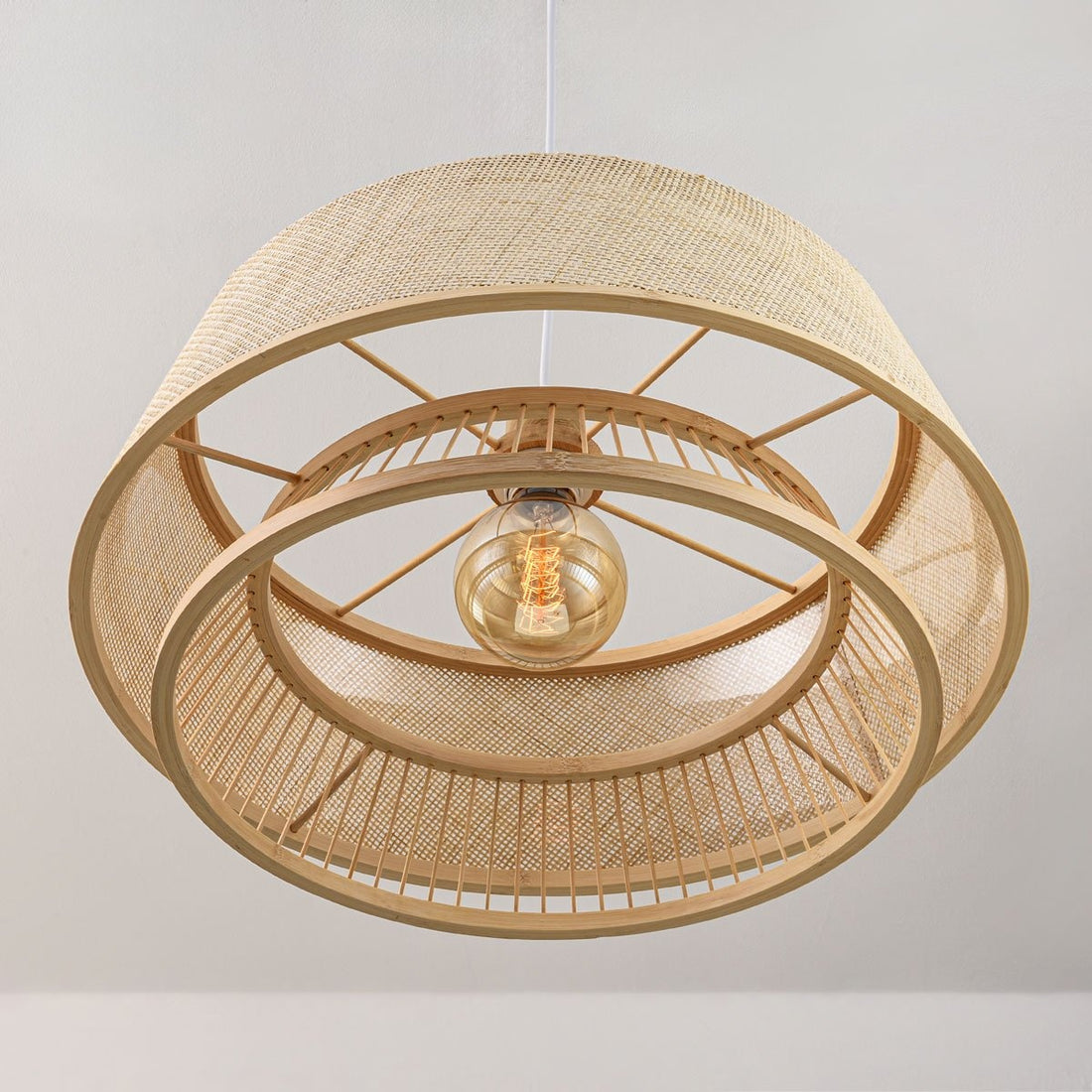 Ambient lighting and shadow patterns created by bamboo pendant light on ceiling