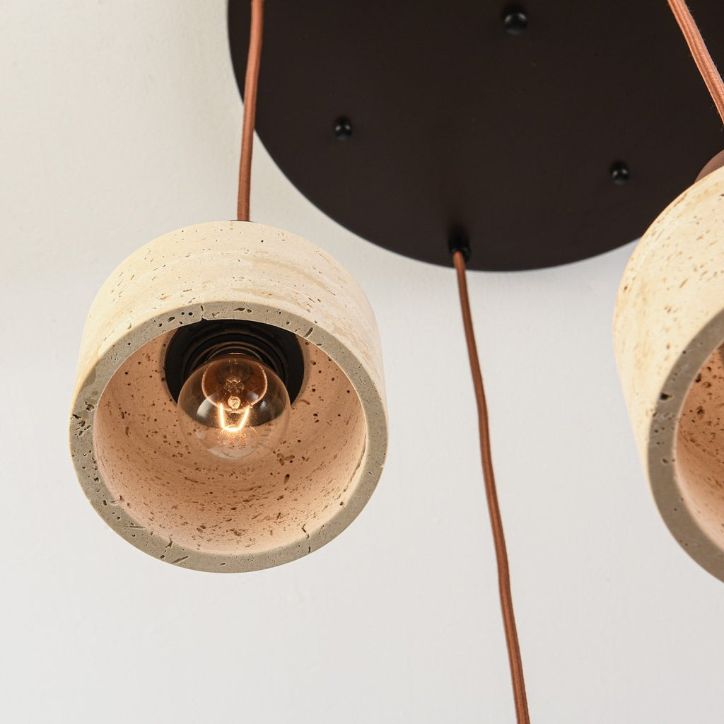 Taoka four light pendant illuminated above dining table in modern interior