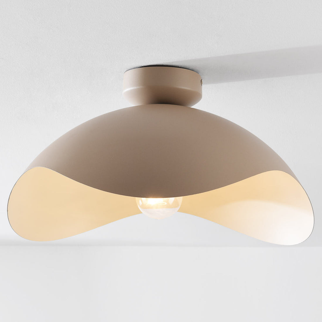 Nami sand taupe metal ceiling light illuminated in modern interior room setting