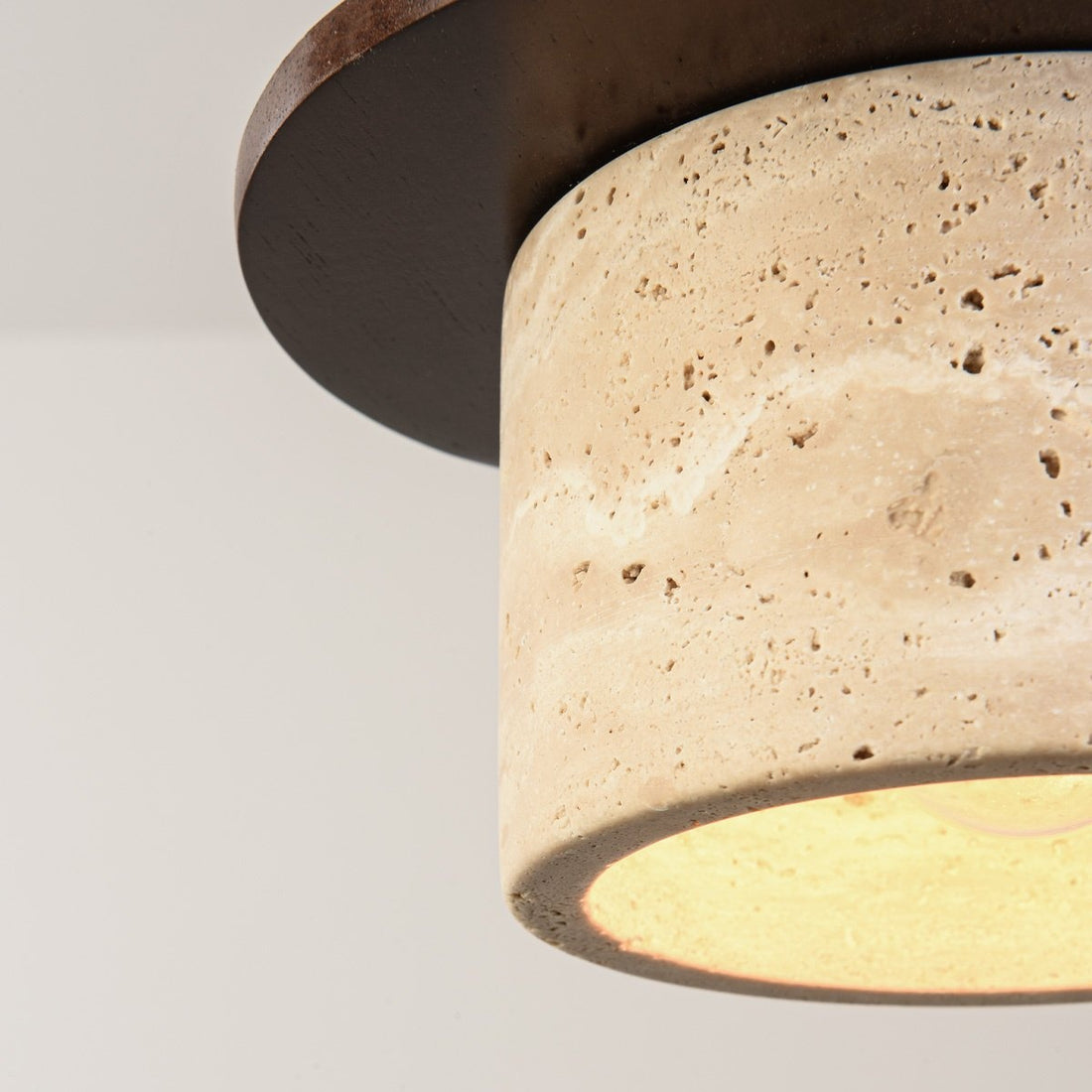 Hoshi single pendant light illuminated showing warm ambient glow in living space