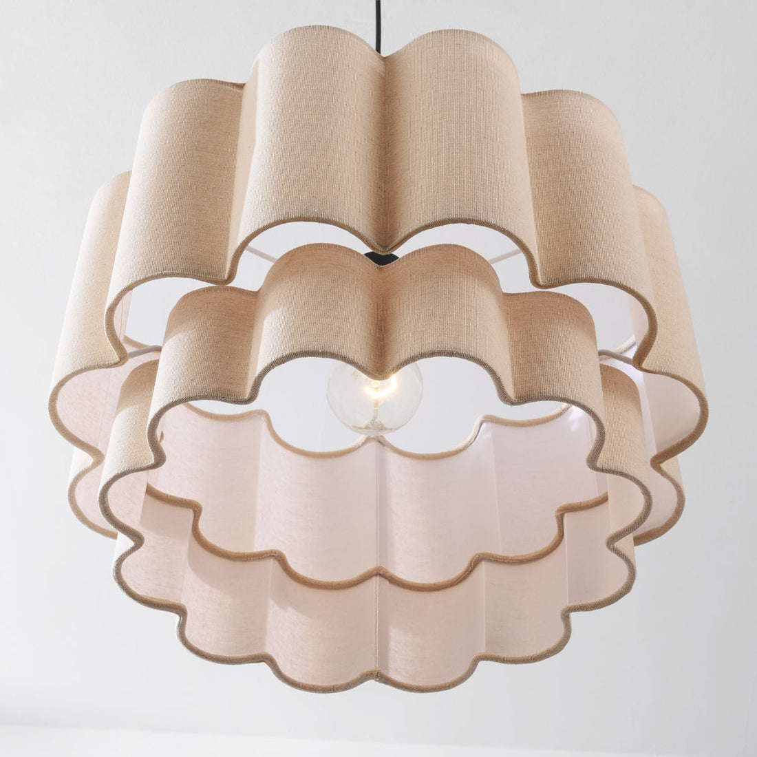 Yuki beige pendant light illuminated showing warm diffused glow through fabric