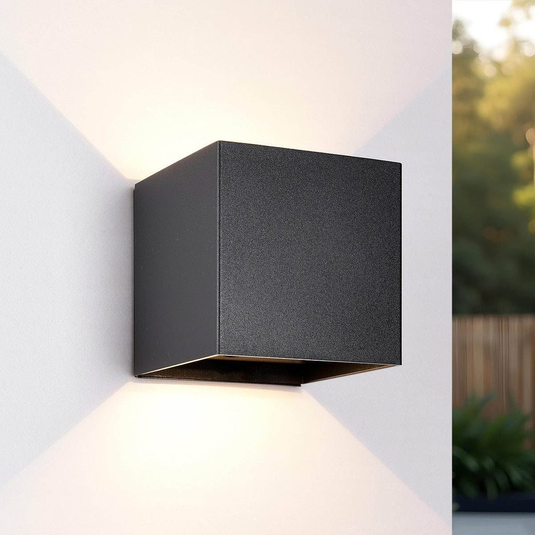 Black rechargeable outdoor wall light with motion sensor mounted on exterior wall
