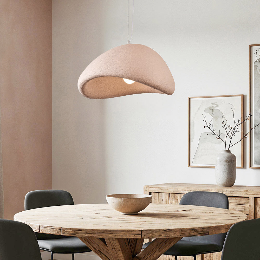 Kara dusty pink organic stone-effect pendant light hanging above dining table