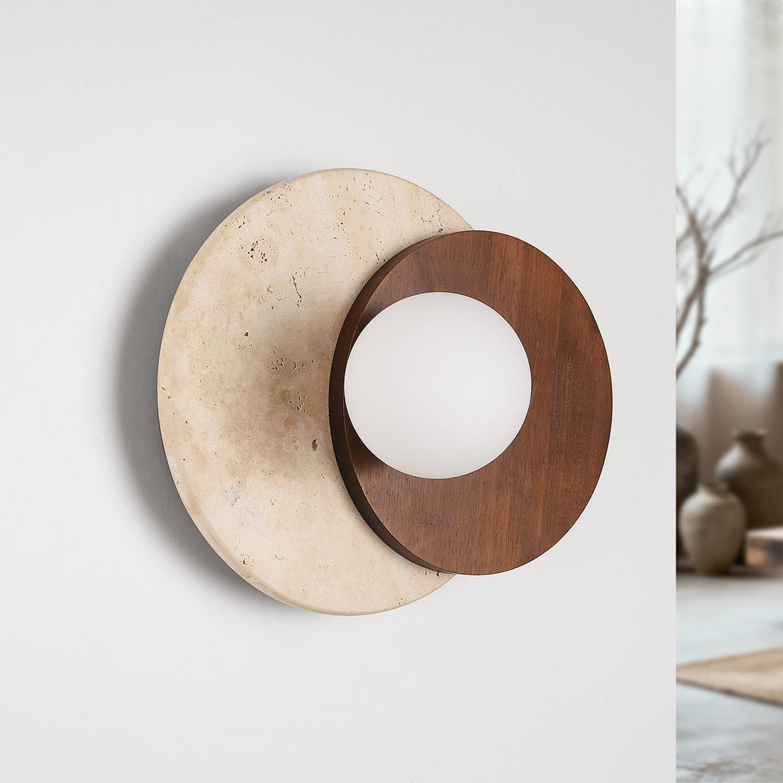 Close up detail of natural travertine stone disc and wood finish on Yori wall light