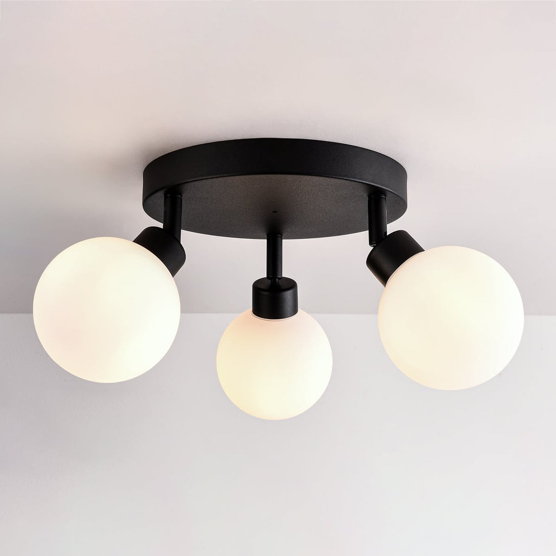 Otto black triple spot ceiling light with opal glass globes