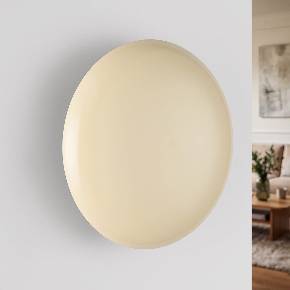 Compact cream wall light showing rounded silhouette and soft glow