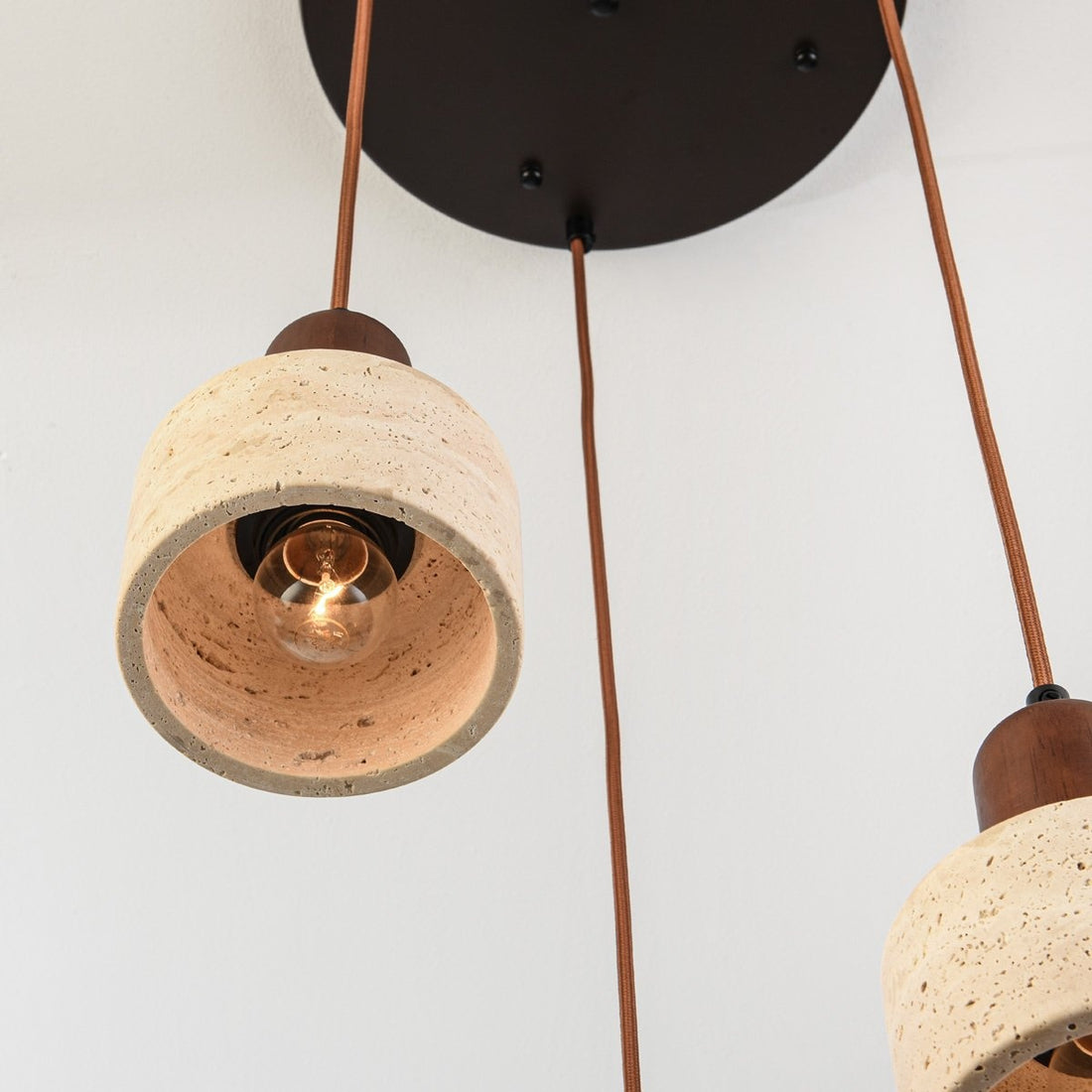Taoka triple pendant light with staggered heights in modern living room