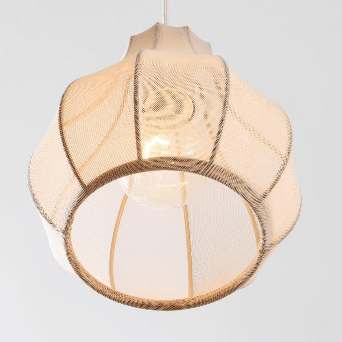 Aiko five-light pendant bar illuminated showing warm ambient glow