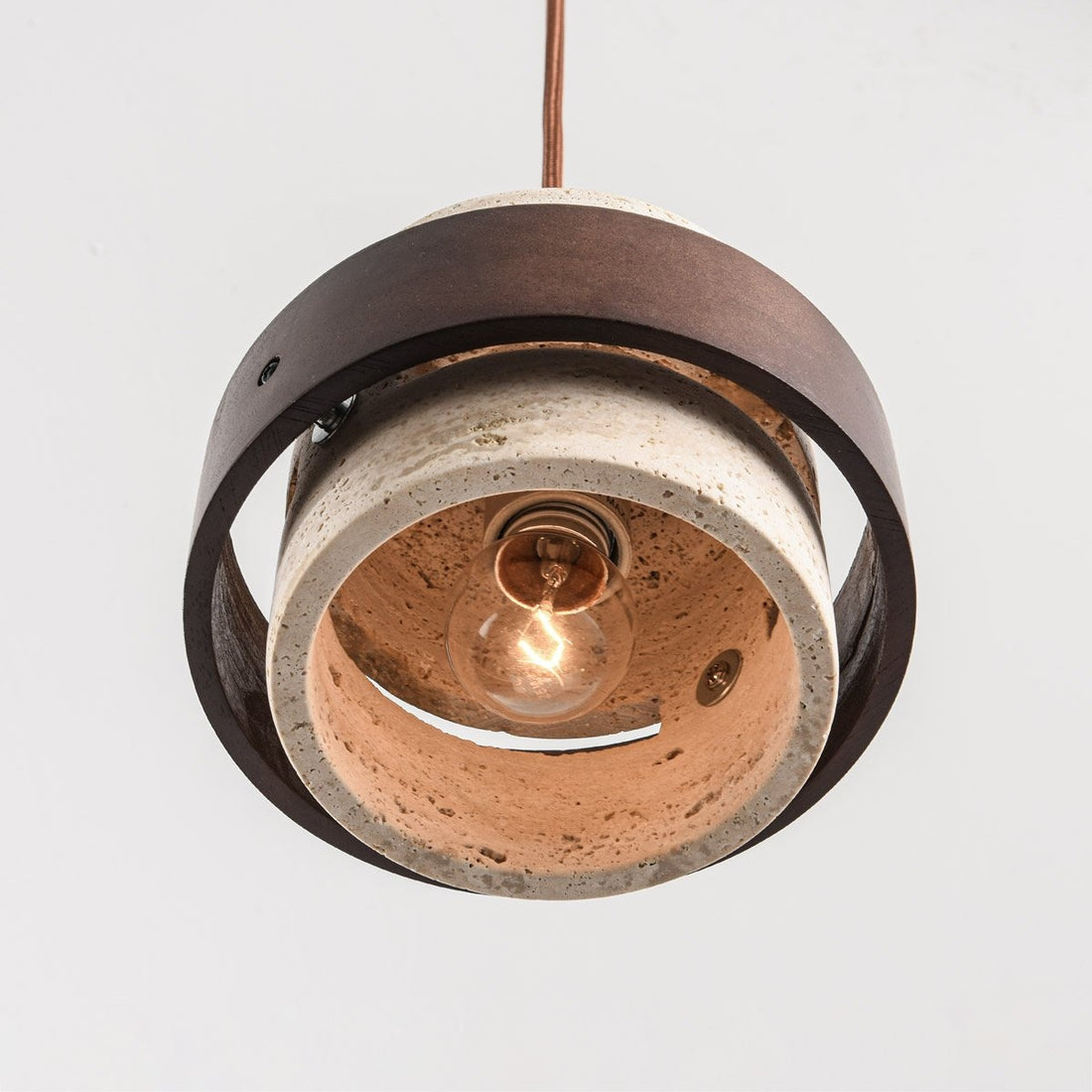 Close up of travertine stone and wood detail on Tsumi pendant light