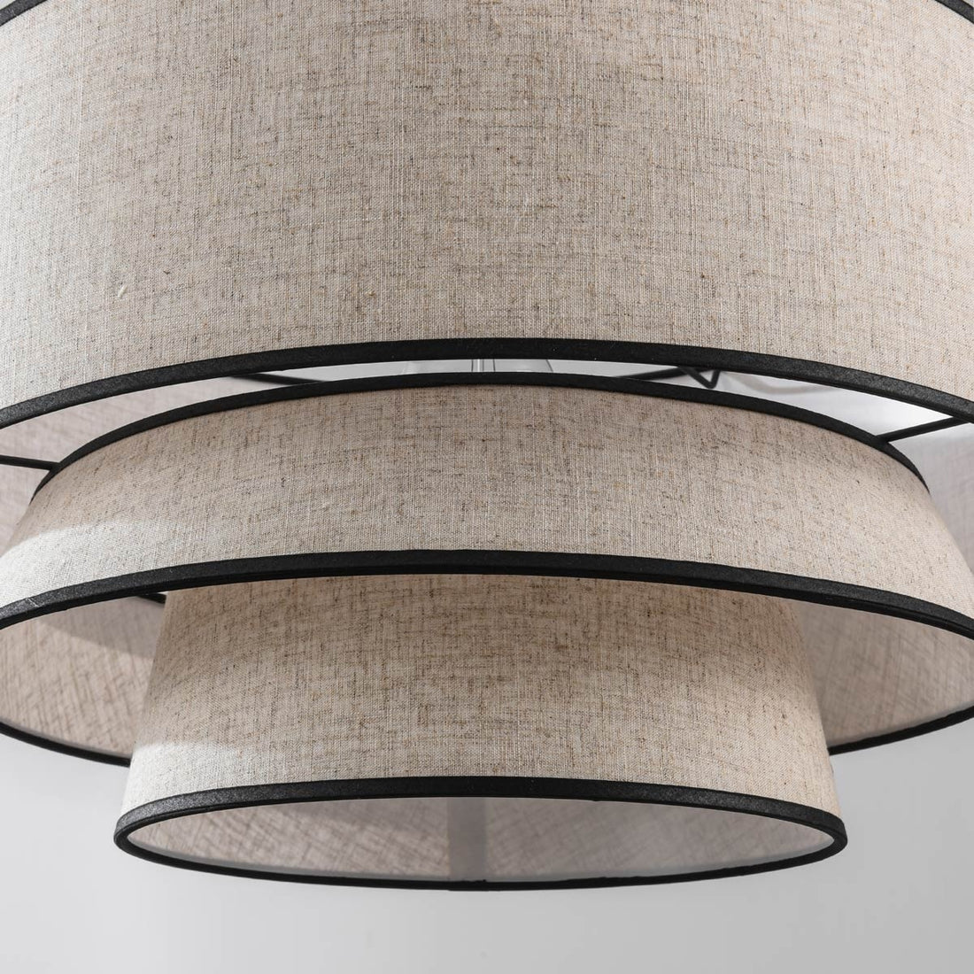 Nori linen pendant light illuminated creating warm ambient glow in bedroom setting