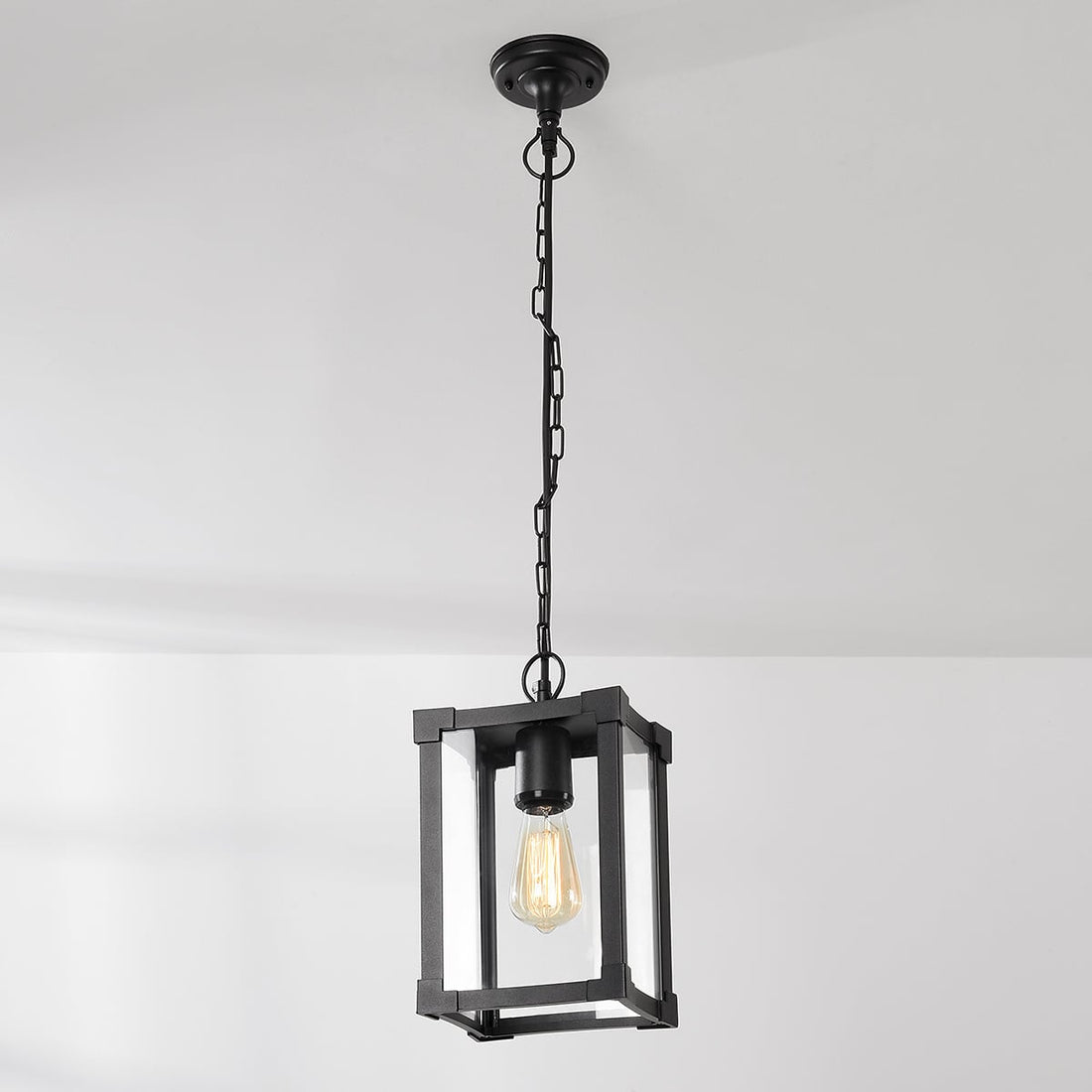 Holt outdoor pendant light illuminated at night creating atmospheric lighting patterns