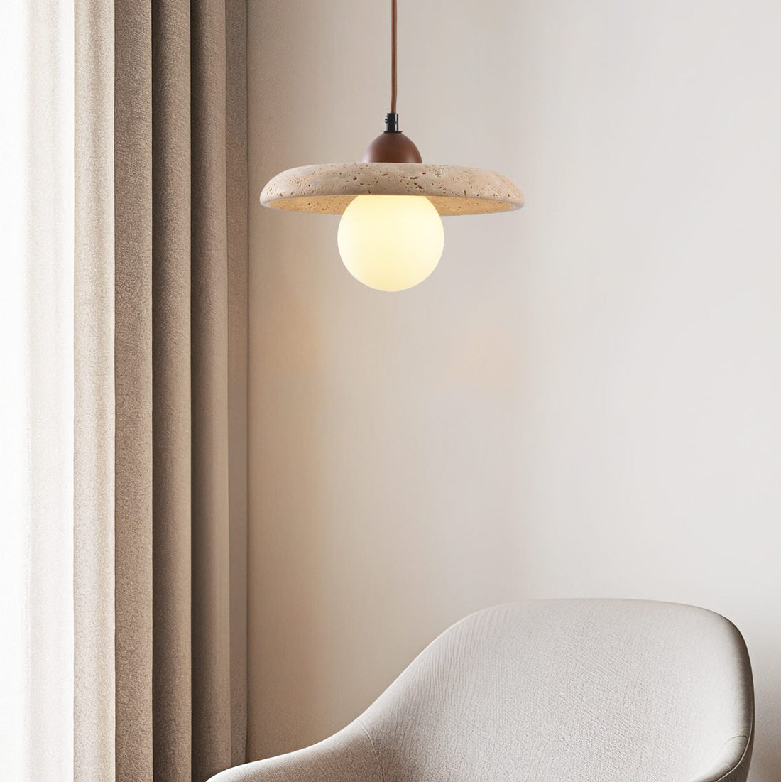 Kiyomi beige travertine and glass pendant light hanging over breakfast bar