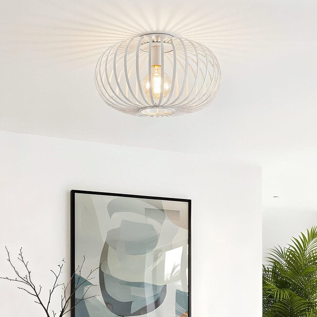 Close-up of white metal cage ceiling light showing intricate ironwork detail