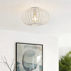 Close-up of white metal cage ceiling light showing intricate ironwork detail