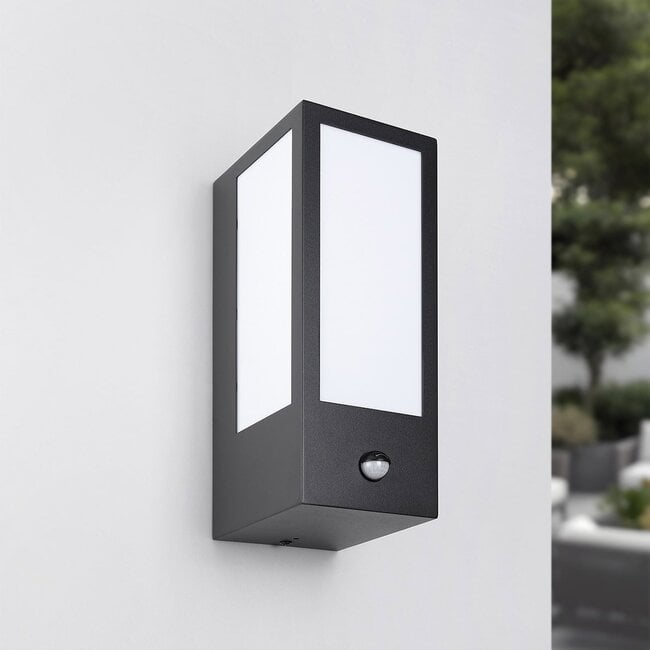 Lyon outdoor wall light with motion sensor illuminated at night on house exterior