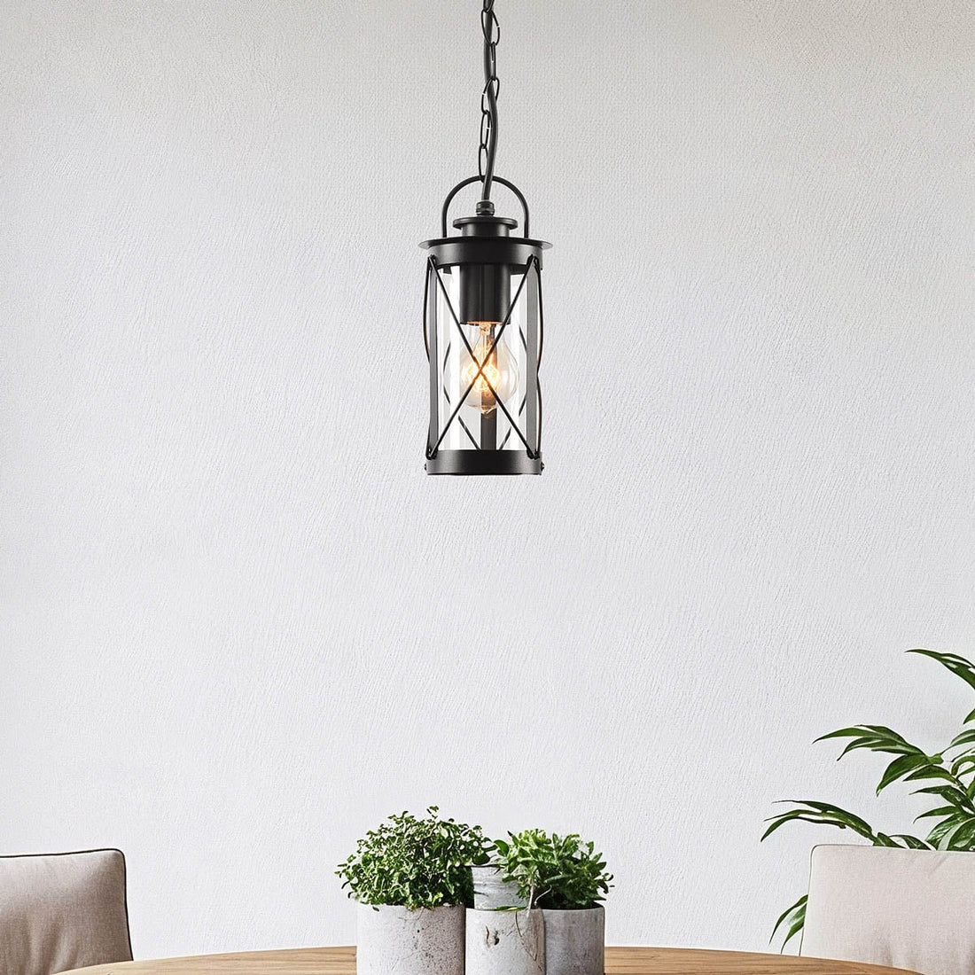 Malmo black lantern outdoor pendant light hanging above a table on a covered terrace