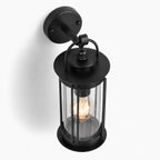 Alicia black industrial outdoor wall lantern, close-up angled view of the glass cage