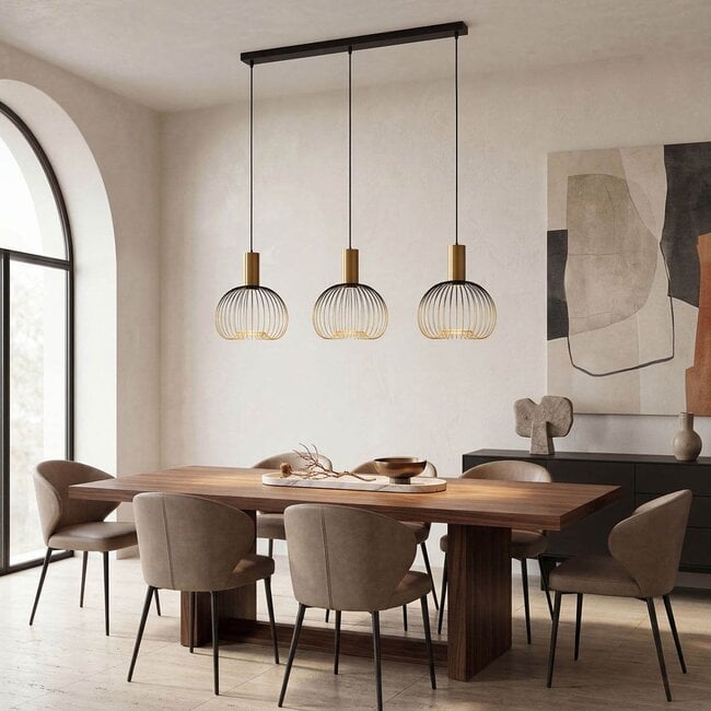 Close-up of Velia pendant light showing industrial cage design with gold interior