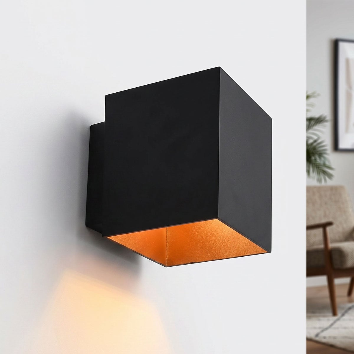 Fay modern square wall light in black finish with gold interior showing up and down light effect