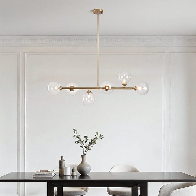 Close up of Calla pendant light showing clear glass shade and brass gold detailing