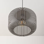 Raina grey sphere pendant light illuminated in modern dining room setting