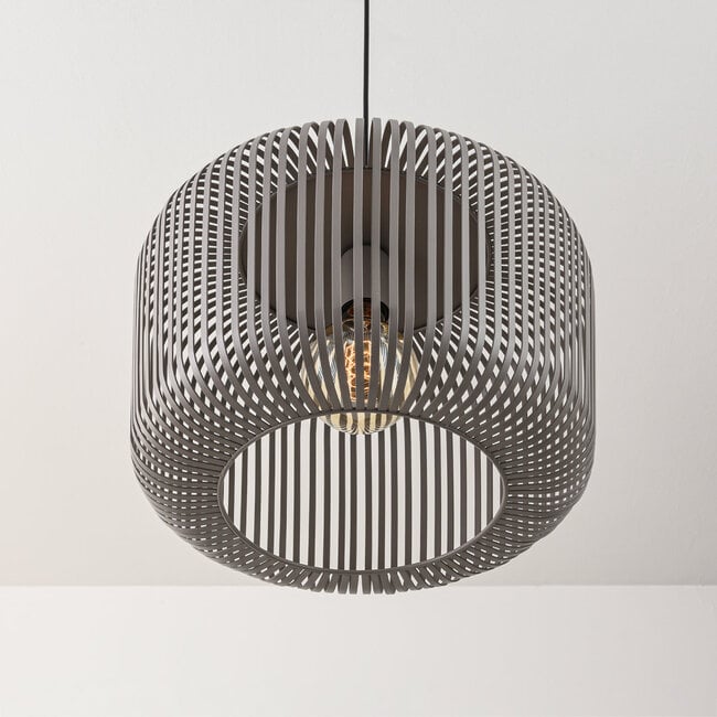 Raina grey sphere pendant light illuminated in modern dining room setting