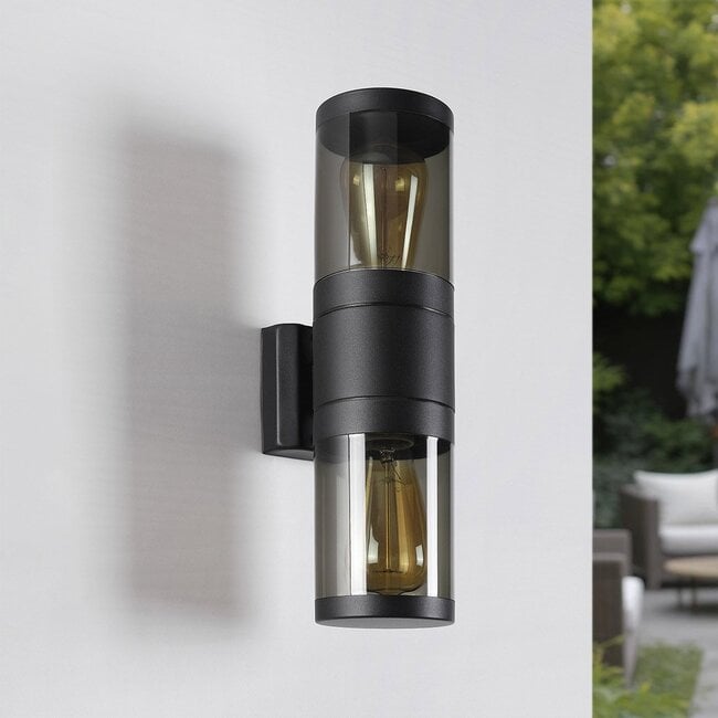 Rouen outdoor wall light in black finish illuminated at night