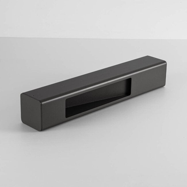 Anthracite bollard post light illuminating driveway border at night